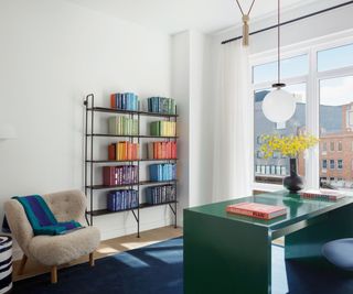 Green table, blue rug, fluffy chair