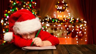 A child writing a wish list at Christmas