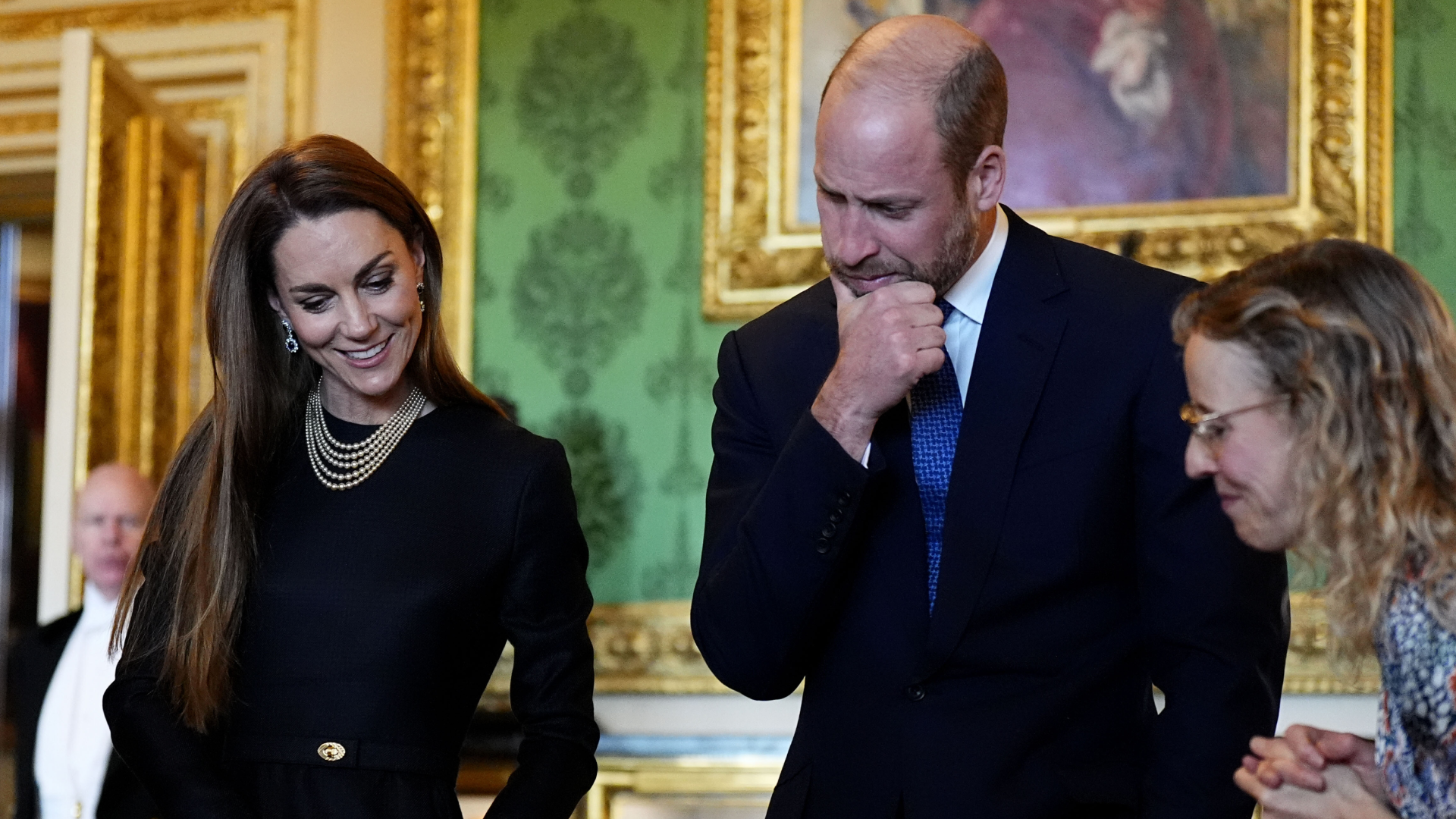 Prince William and Kate Middleton looking down at artwork