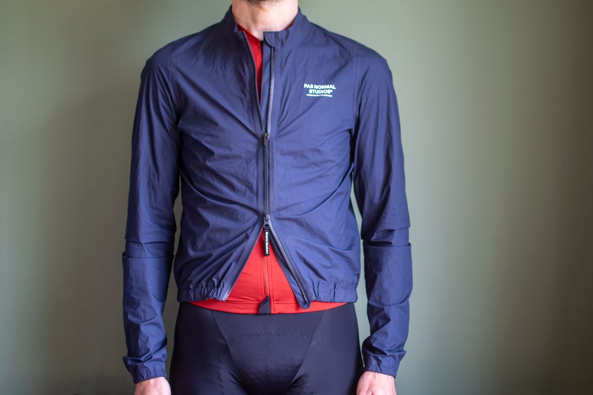 A man wearing a Pas Normal Pertex rain jacket