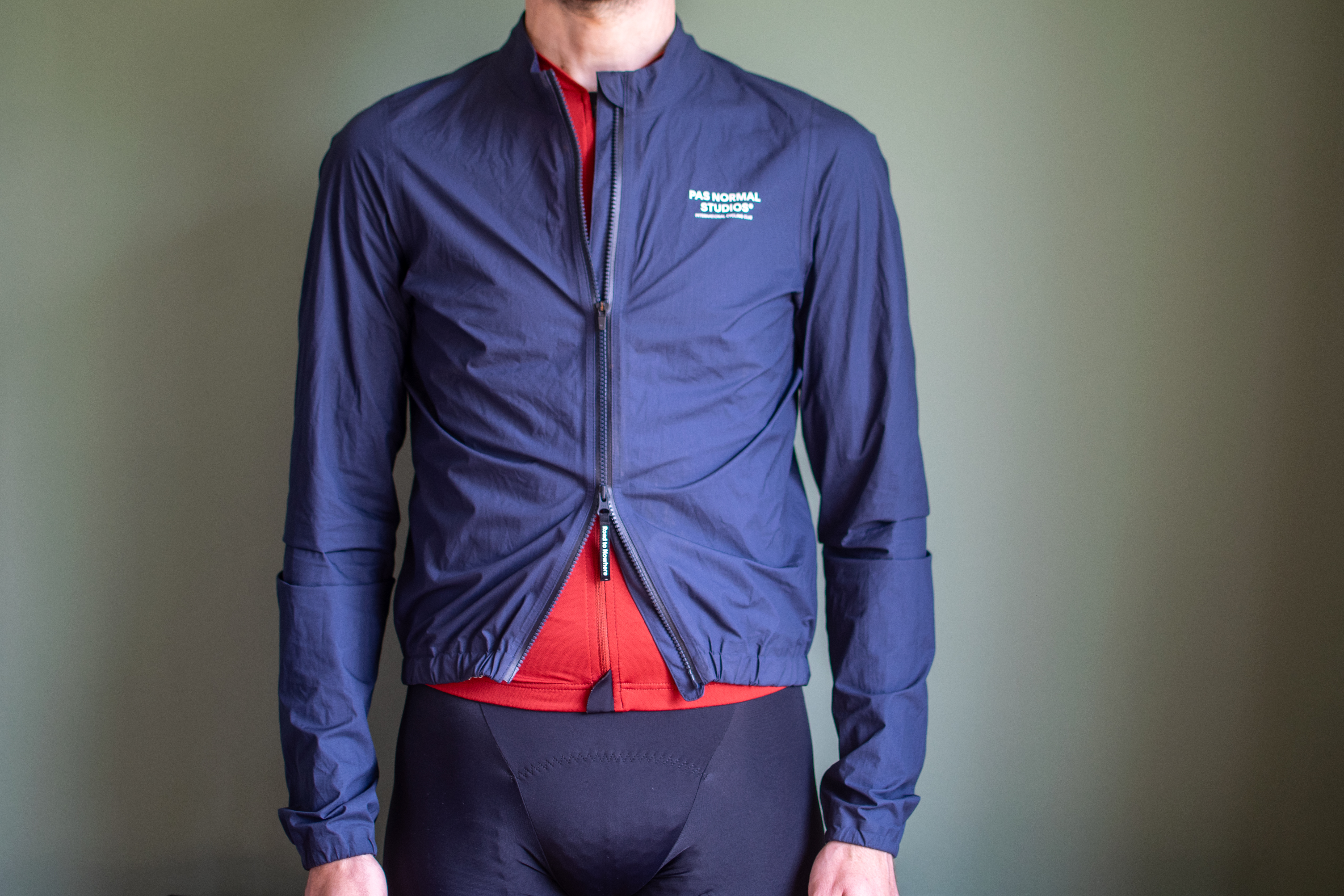 A man wearing a Pas Normal Pertex rain jacket