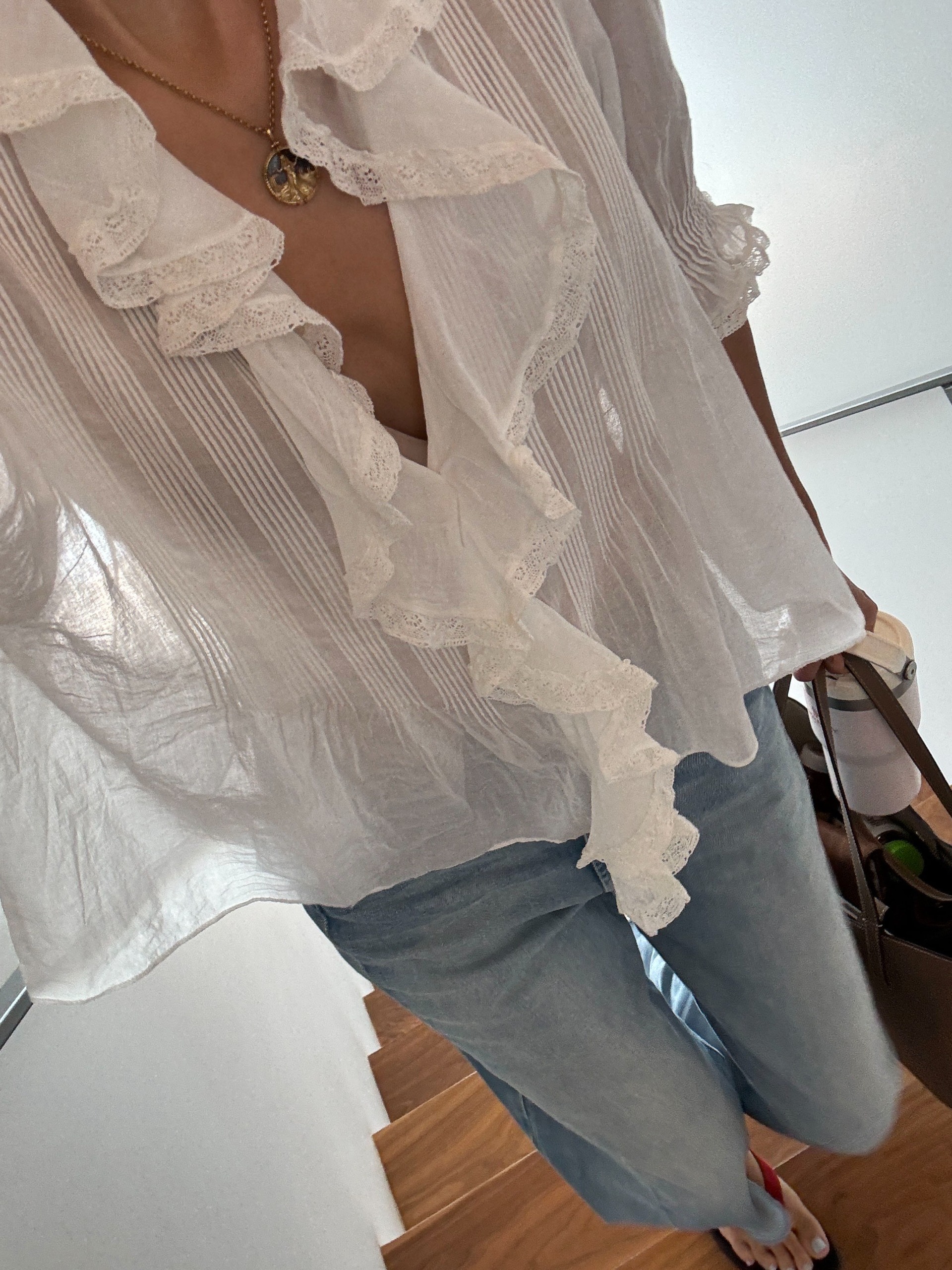 Woman in a white blouse and jeans.