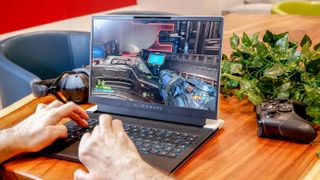 Alienware x14 on a desk with a game being played