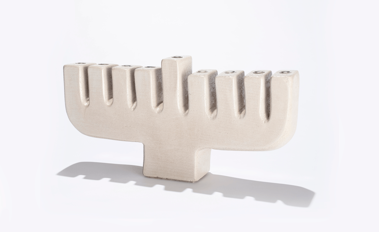 concrete menorah against a white background