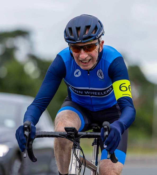 Case study rider Michael Currid riding in blue and black kit