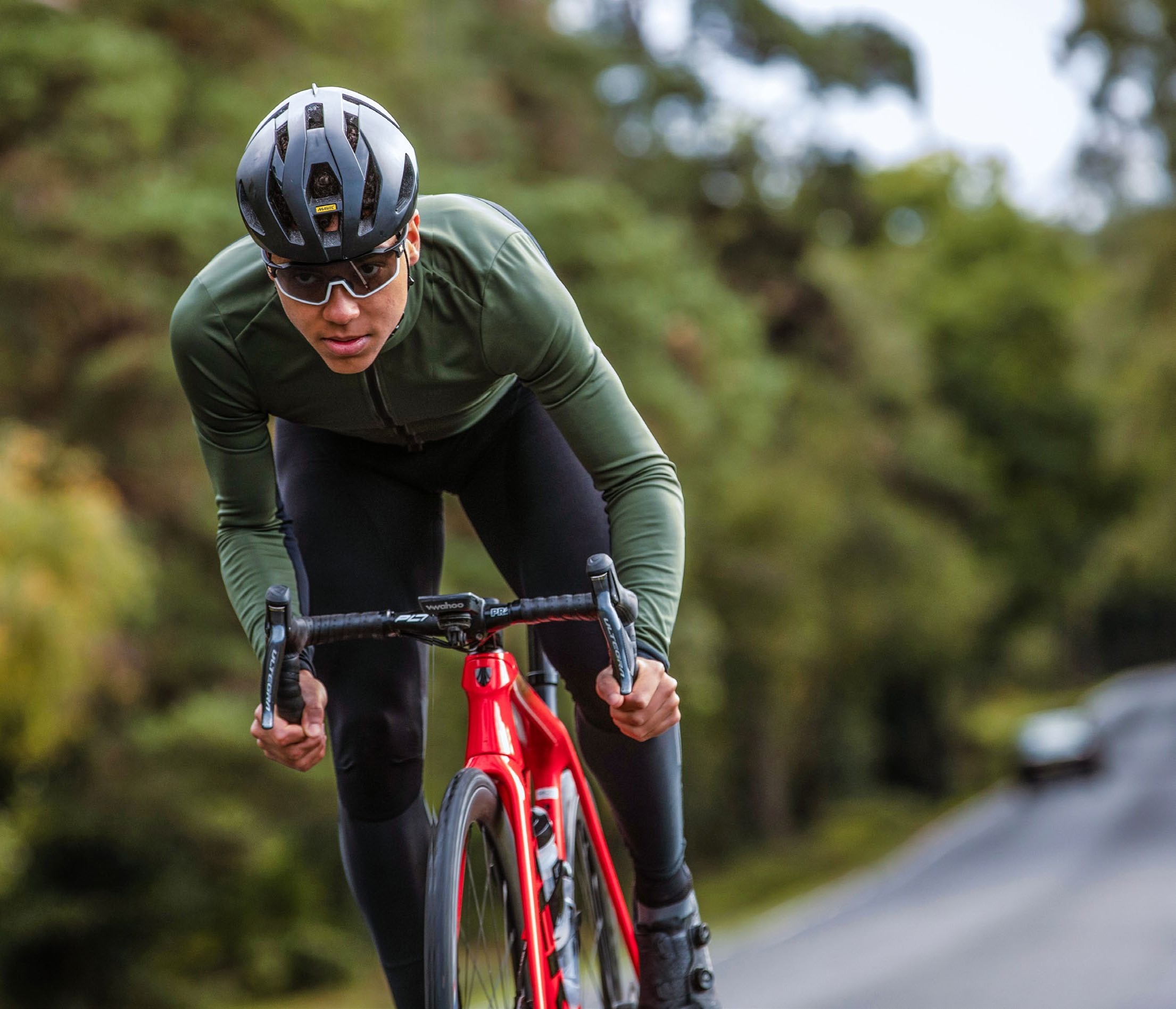 Red Walters riding in dark kit on a red bike