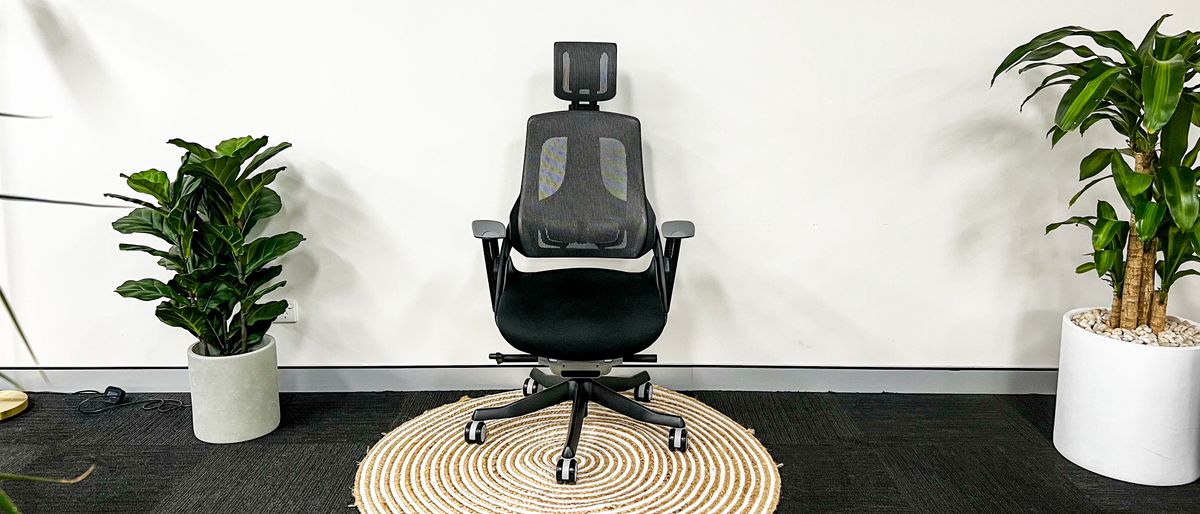 Desky Pro Plus Ergonomic Chair standing on a circular mat against a white wall