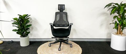 Desky Pro Plus Ergonomic Chair standing on a circular mat against a white wall