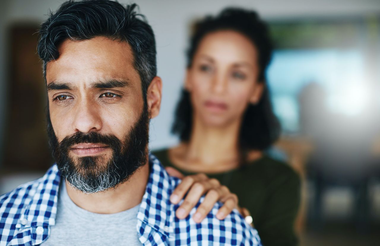 Woman comforting distraught man.