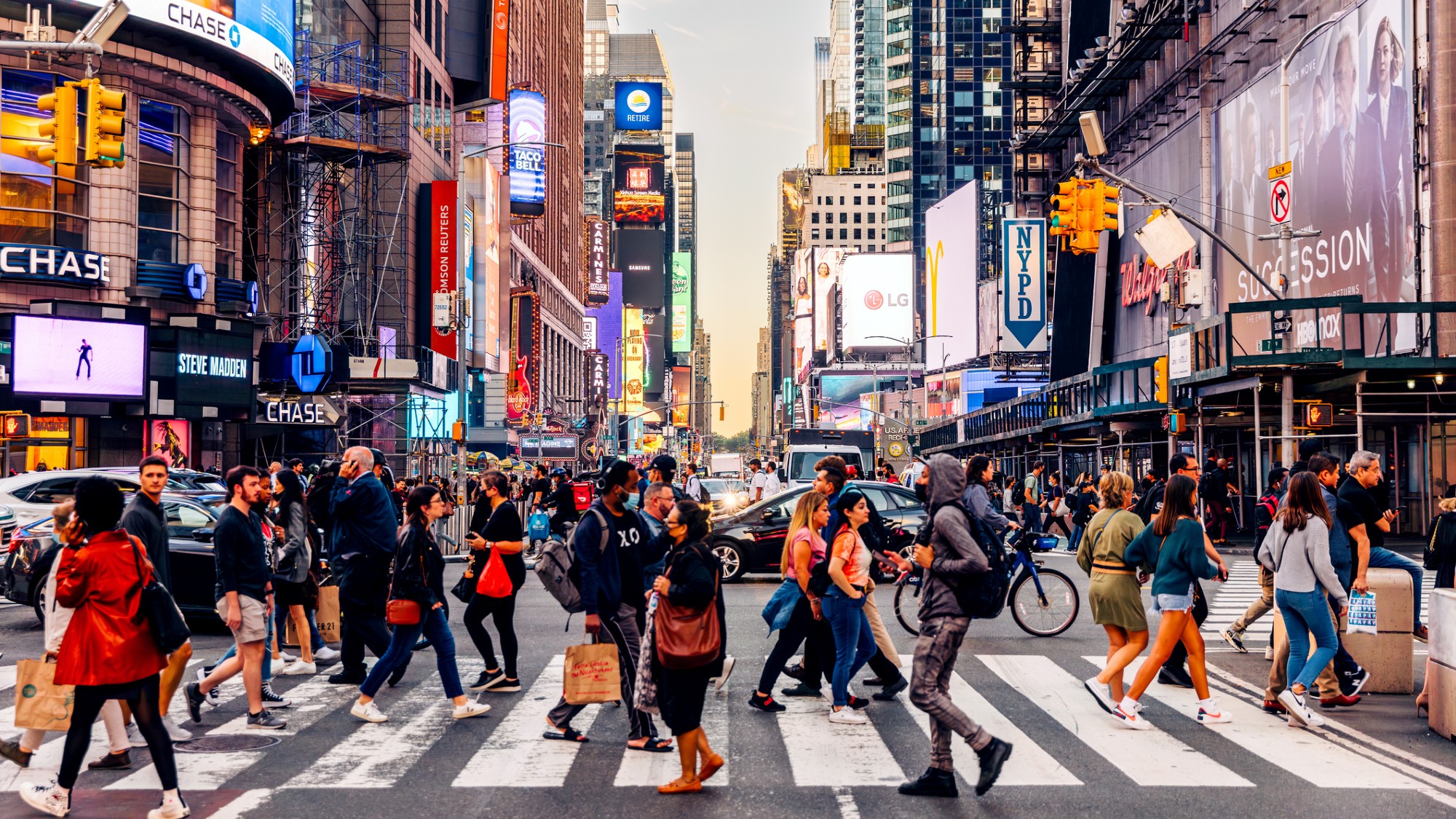 People cross a city street in Manhattan.