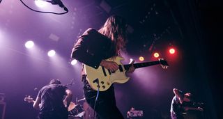 Pigs Pigs Pigs Pigs Pigs Pigs Pigs' guitarist Adam Ian Sykes plays his white Gibson SG onstage