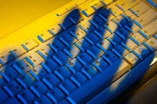 Hand casting a shadow over a keyboard