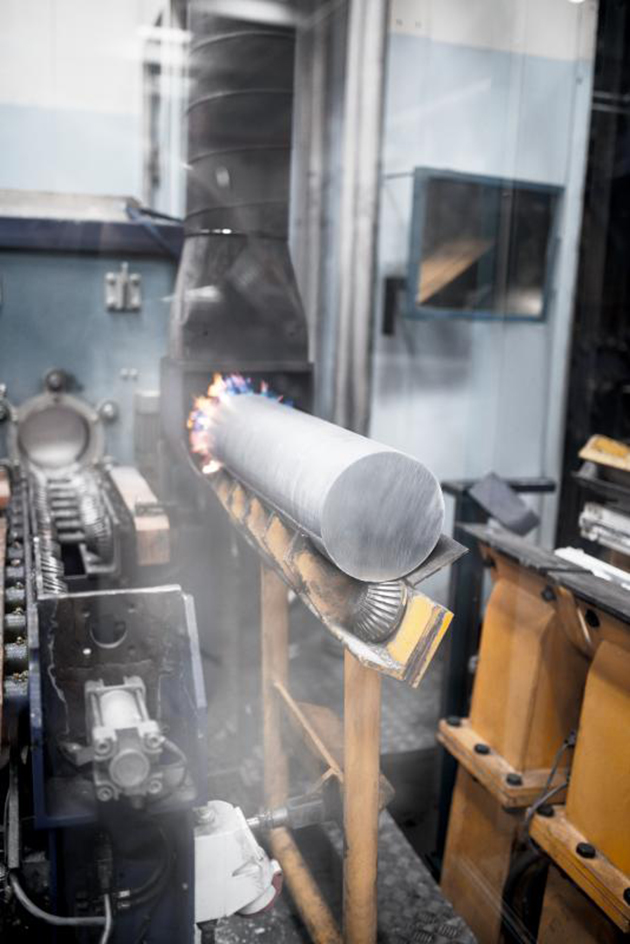 Aluminium billet being prepped for the extrusion process