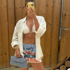 Cass Dimicco in a white bikini and blue Aureum bag