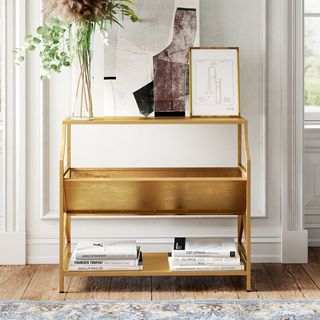 A gold bookcase that's a part of Kelly Clarkson's furniture collection.