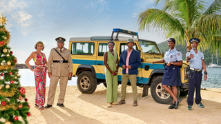 From left to right: Élizabeth Bourgine (as Catherine Border), Don Warrington (Commissioner Selwyn Patterson), Shantol Jackson (DS Naomi Thomas), Don Gilet (DI Mervin Wilson), Ginny Holder (Darlene Curtis) and Danny John-Jules (Officer Dwayne Myers) all feature in this year's "Death in Paradise Christmas Special"