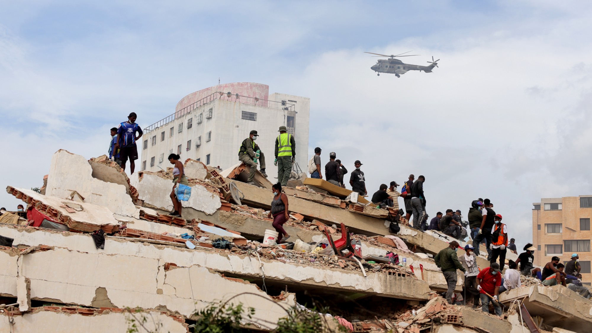 Rescue workers look for survivors after two major earthquakes in Caraballeda, Venezuela. 