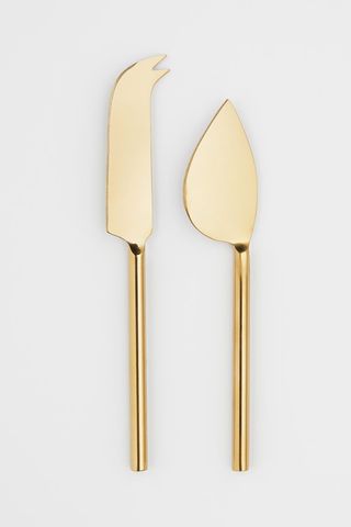 two gold cheese knives