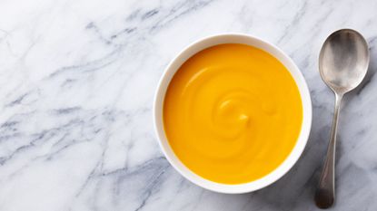 Baby food: mango purée with spoon