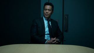Xander Goi (Byron Mann) in a suit and tie