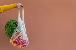 What is a plant-based diet?Woman Holding Reusable Cotton Mesh Bag With Fruit And Vegetables