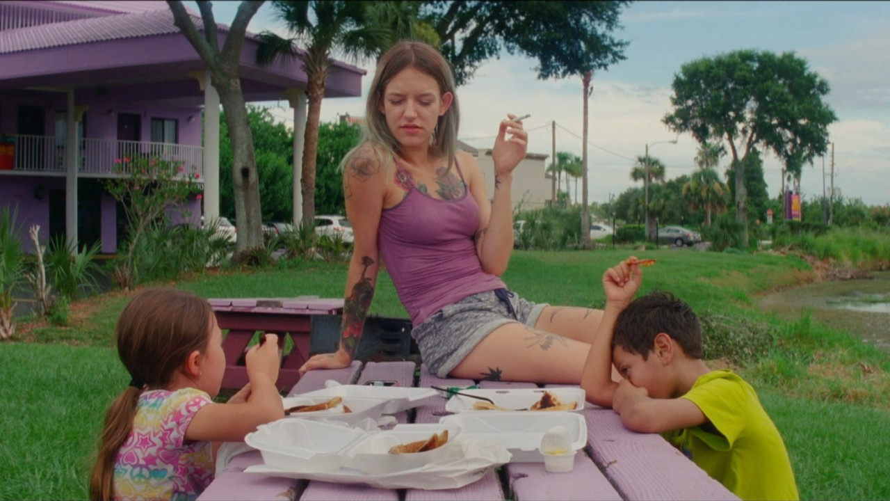 Bria Vinaite looking at Brooklynn Prince with Christopher Rivera nearby on The Florida Project. 