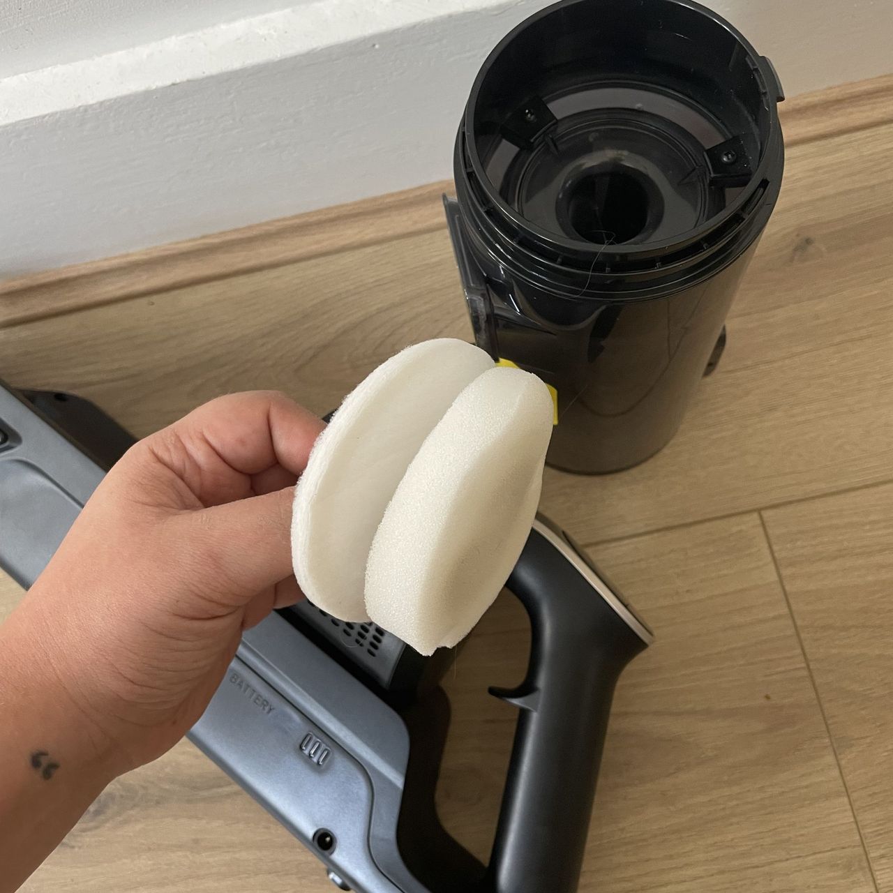 Hand holding the filters of the Hoover HF3 vacuum cleaner