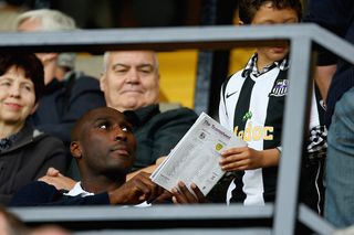 New Notts County Signing Sol Campbell signs a young fan's programme as he watches from the stands during the Coca-Cola League Two match between Notts County and Burton Albion at Meadow Lane on September 5, 2009 in Nottingham, England.