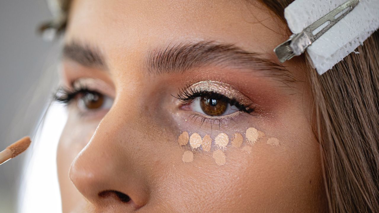 close up of model&#039;s eyes with concealer underneath