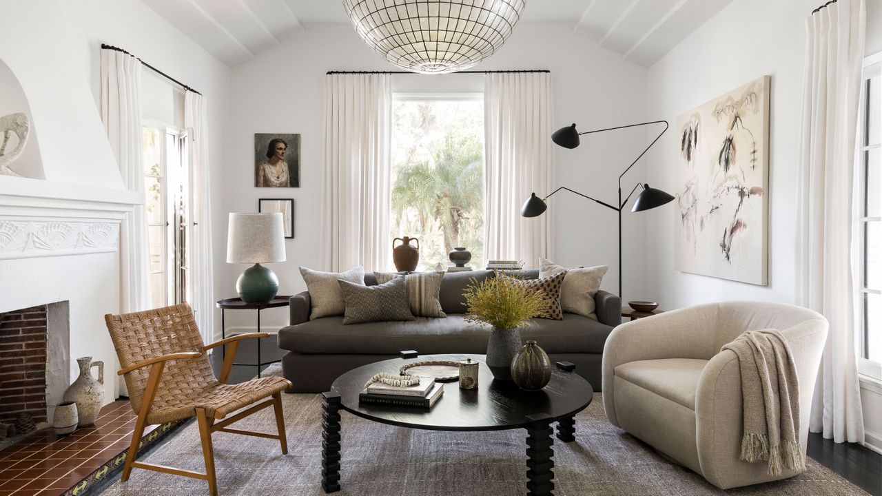 midcentury furniture in living room with white walls and fire surround coffee table with black legs and patterned rug