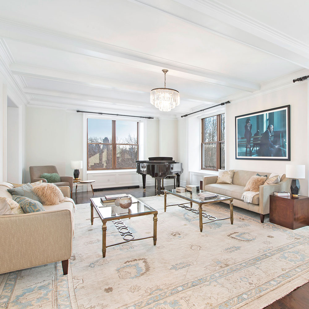 living room with white wall sofa set and chandelier