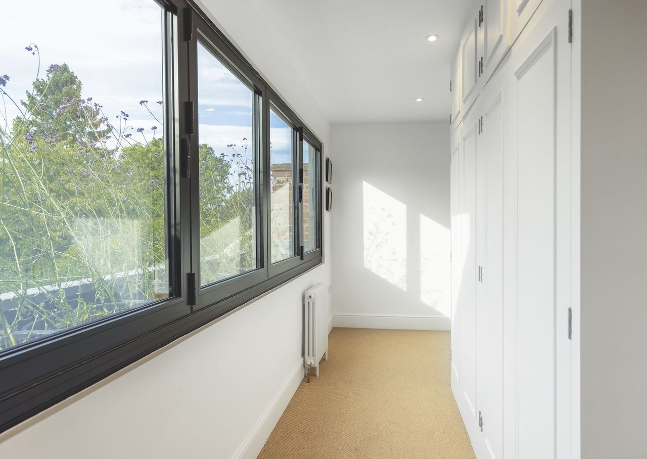 upstairs corridor in two storey extension with built in wardrobes and bifold windows