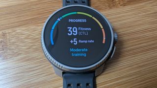 Suunto Race on a bamboo table showing an on screen progress tracker