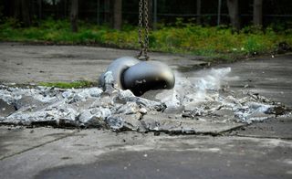 Silver art sculpture crashing into the ground