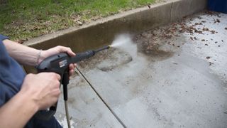 Point of view shot of the RYOBI RY14122 being used to clean a patio