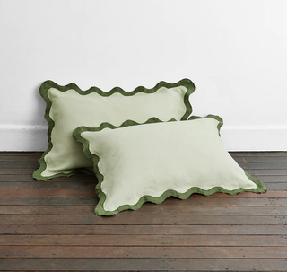 Light green pillowcase with dark green scalloped edge
