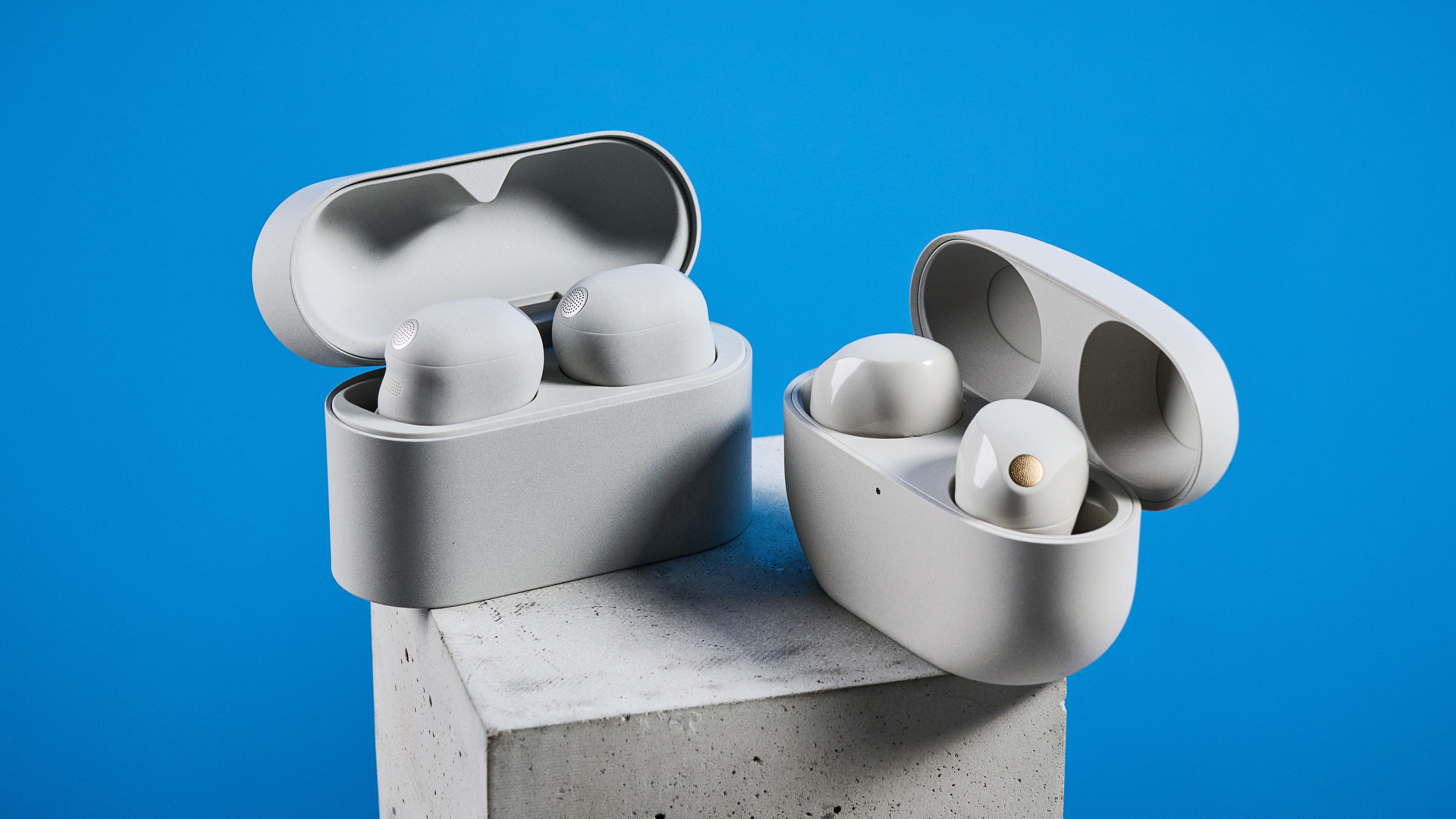 Sony WF-1000XM6 earbuds photographed in front of a blue background