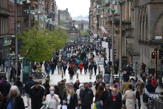 Pedestrians walk around in Glagow, Scotland, as other parts of the UK go into local lockdown