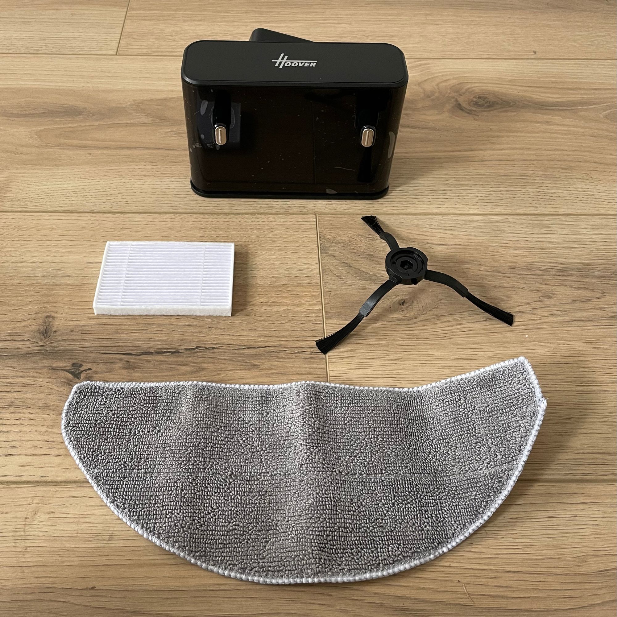Hoover HG2 robot vacuum and mop components laid out on wood-effect flooring
