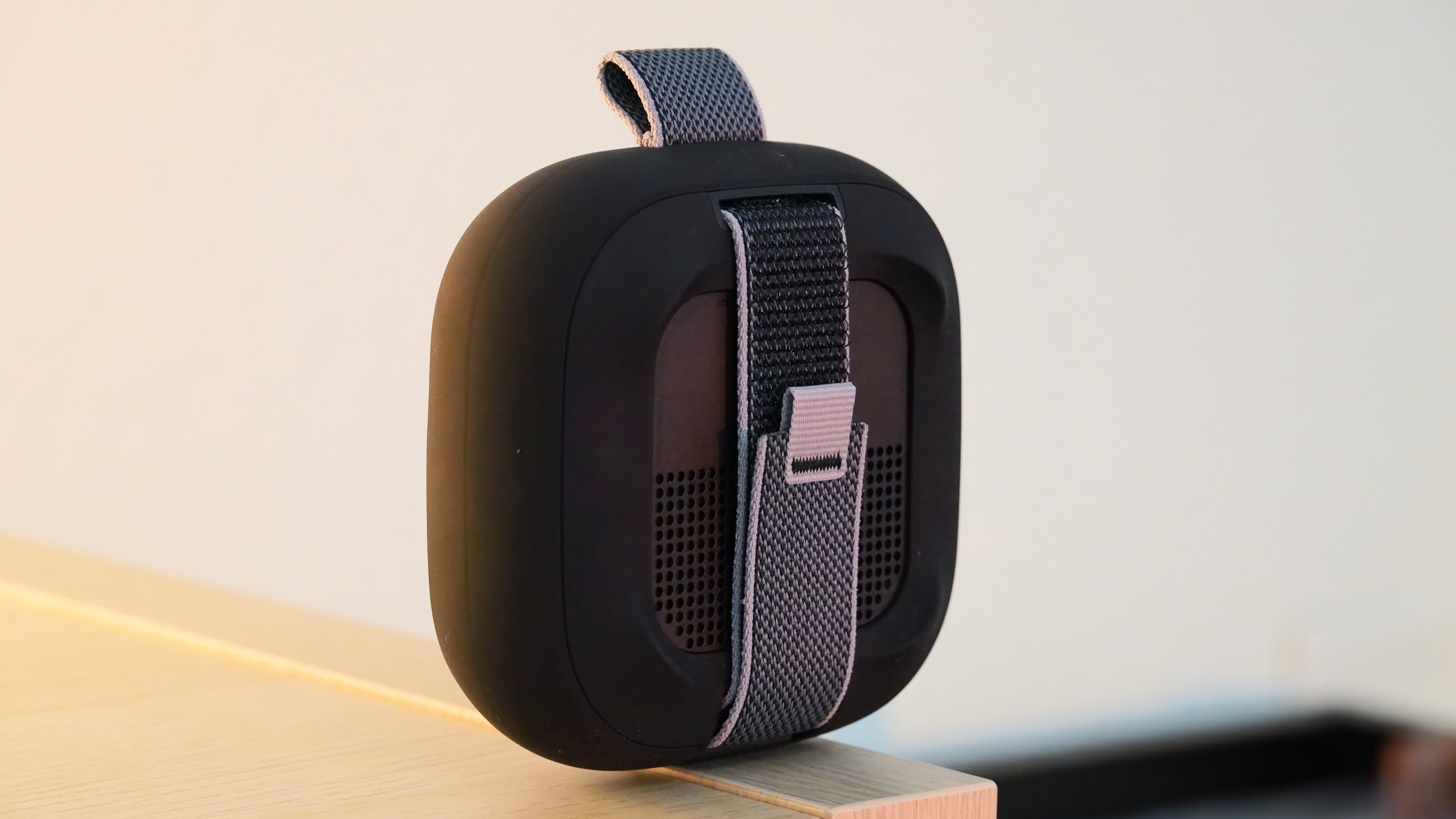 The Bose SoundLink Micro 2 in black showing the back strap.