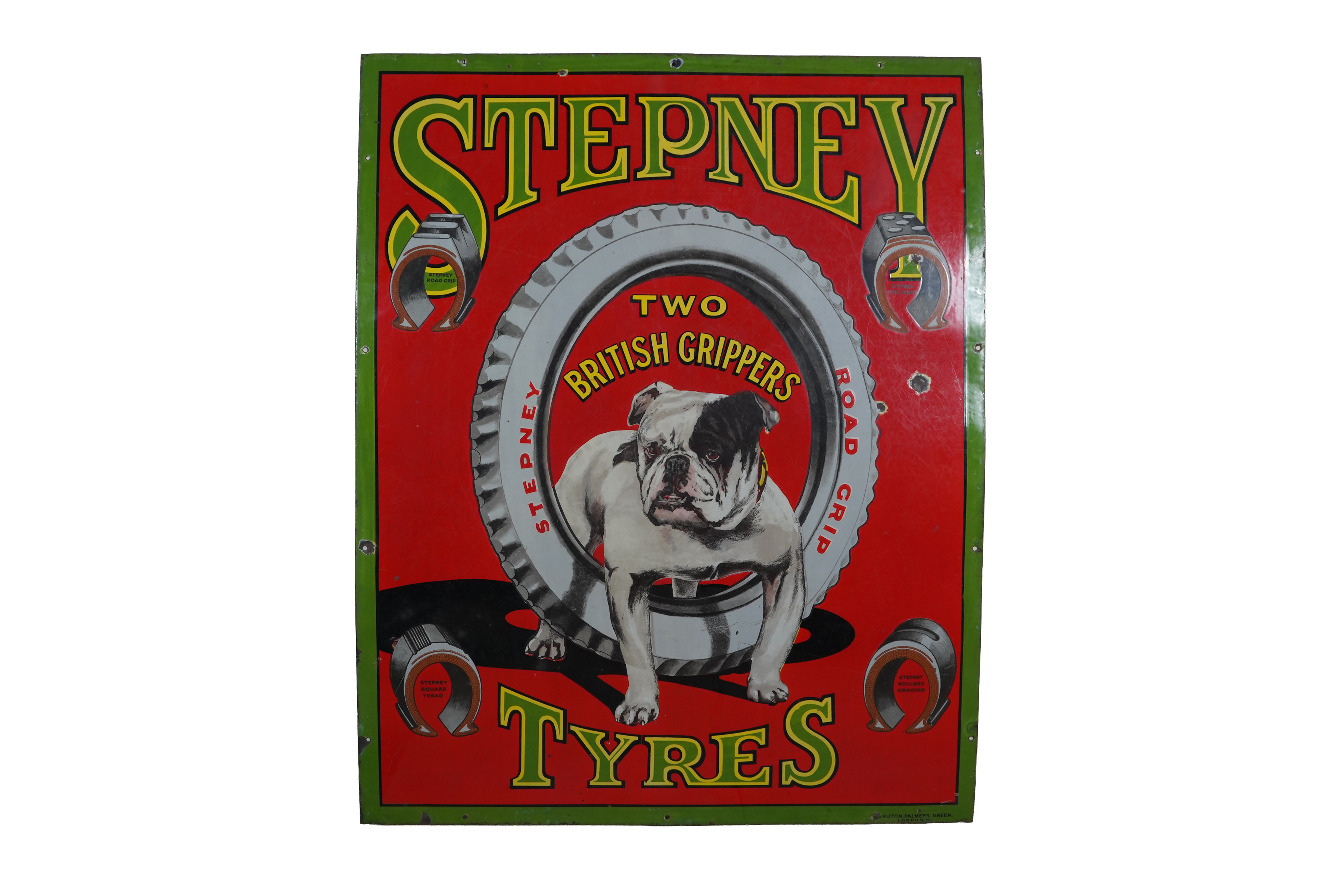 A vintage sign from Stepney showing a bulldog in the middle of a tyre. it says Two British Grippers