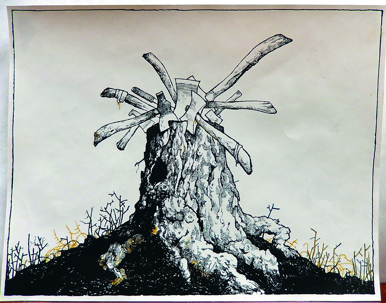 Absurd art; a tree stump with many axes in it