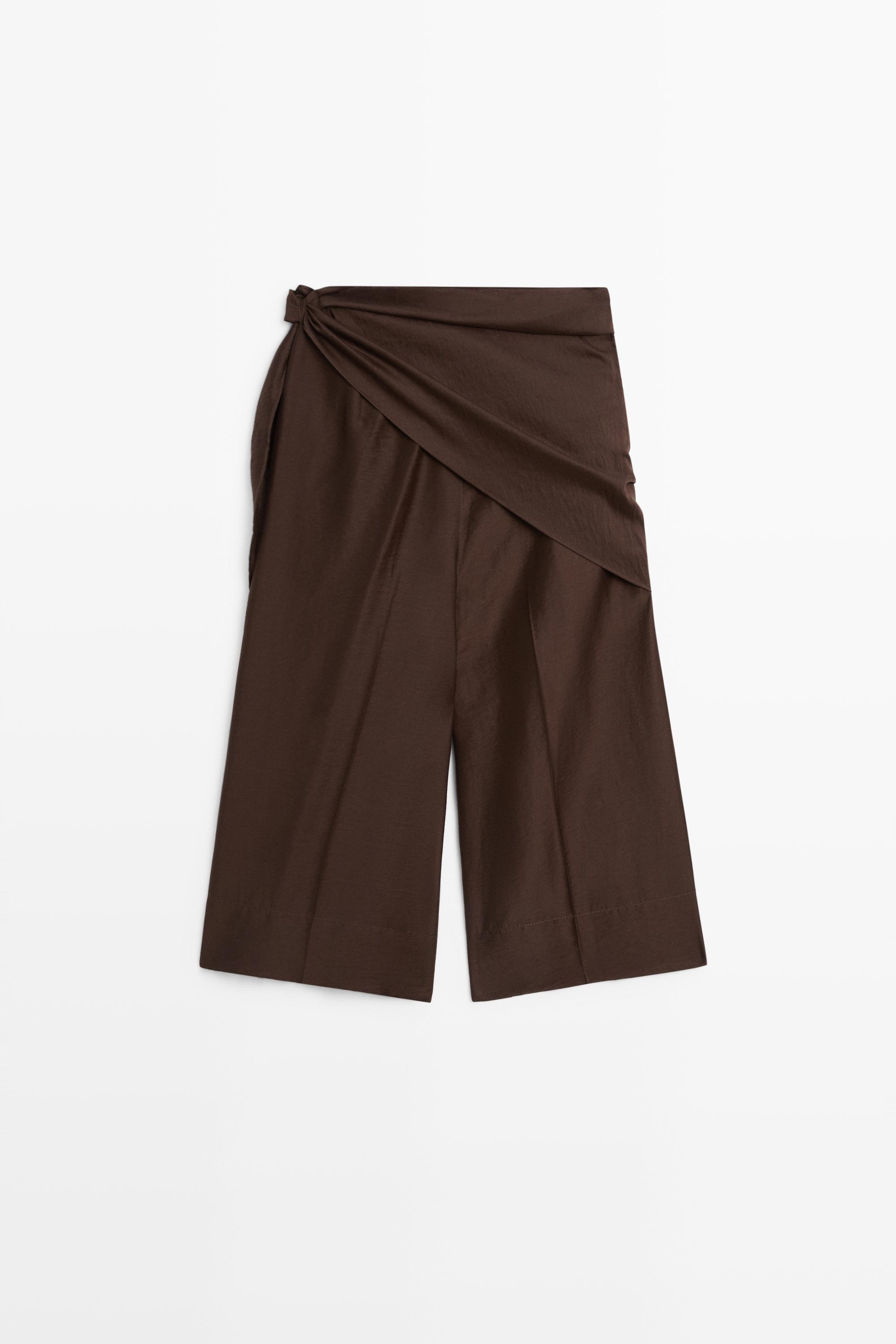 A pair of Massimo Dutti khaki bermuda shorts.