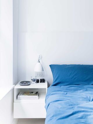 london flat white bedroom blue bedding bedside table