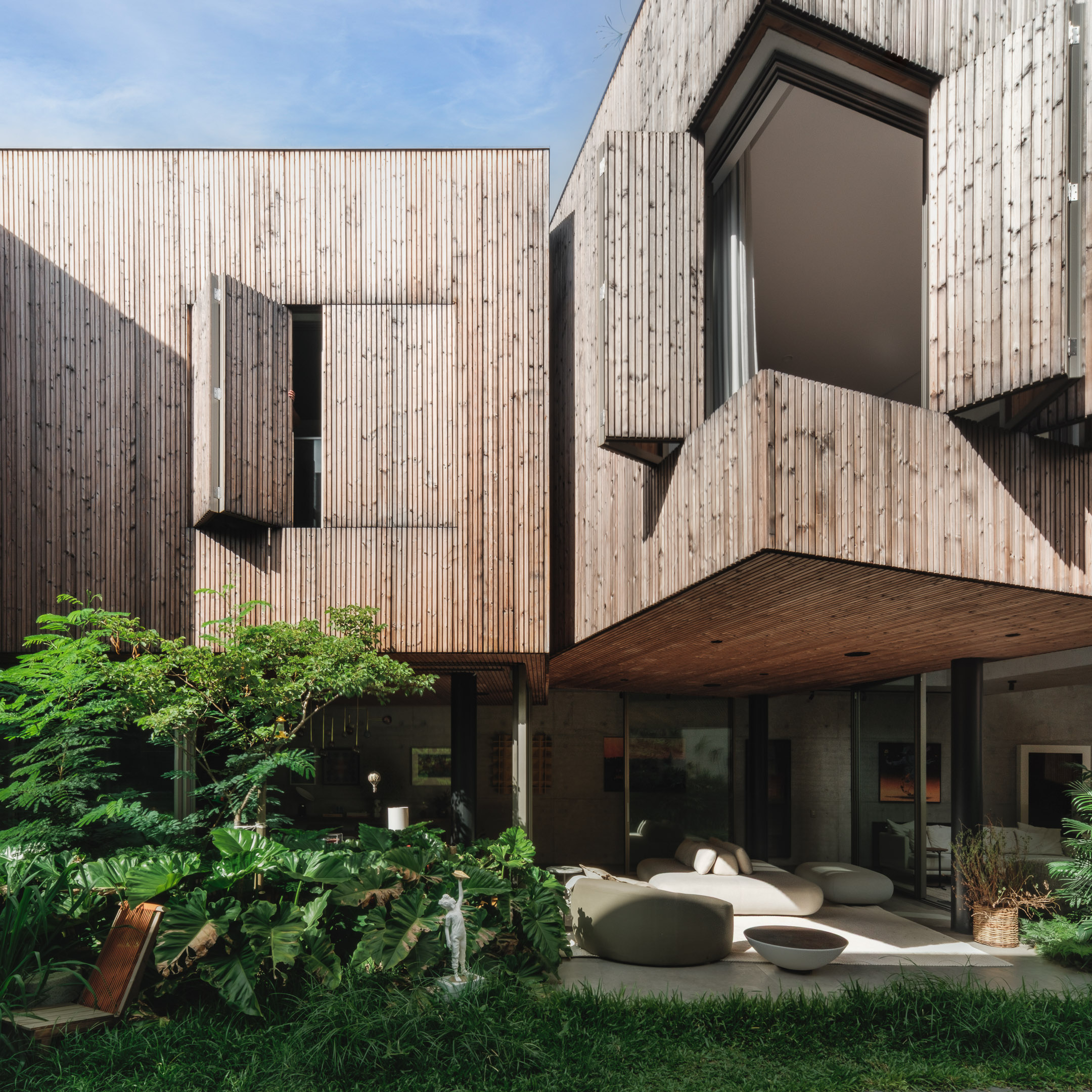 The garden facade features flush-fitting wooden shutters