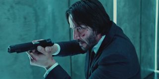 Keanu Reeves holding gun as John Wick