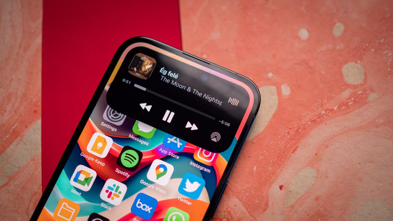 iPhone 14 Pro Dynamic Island showing music playing with controls