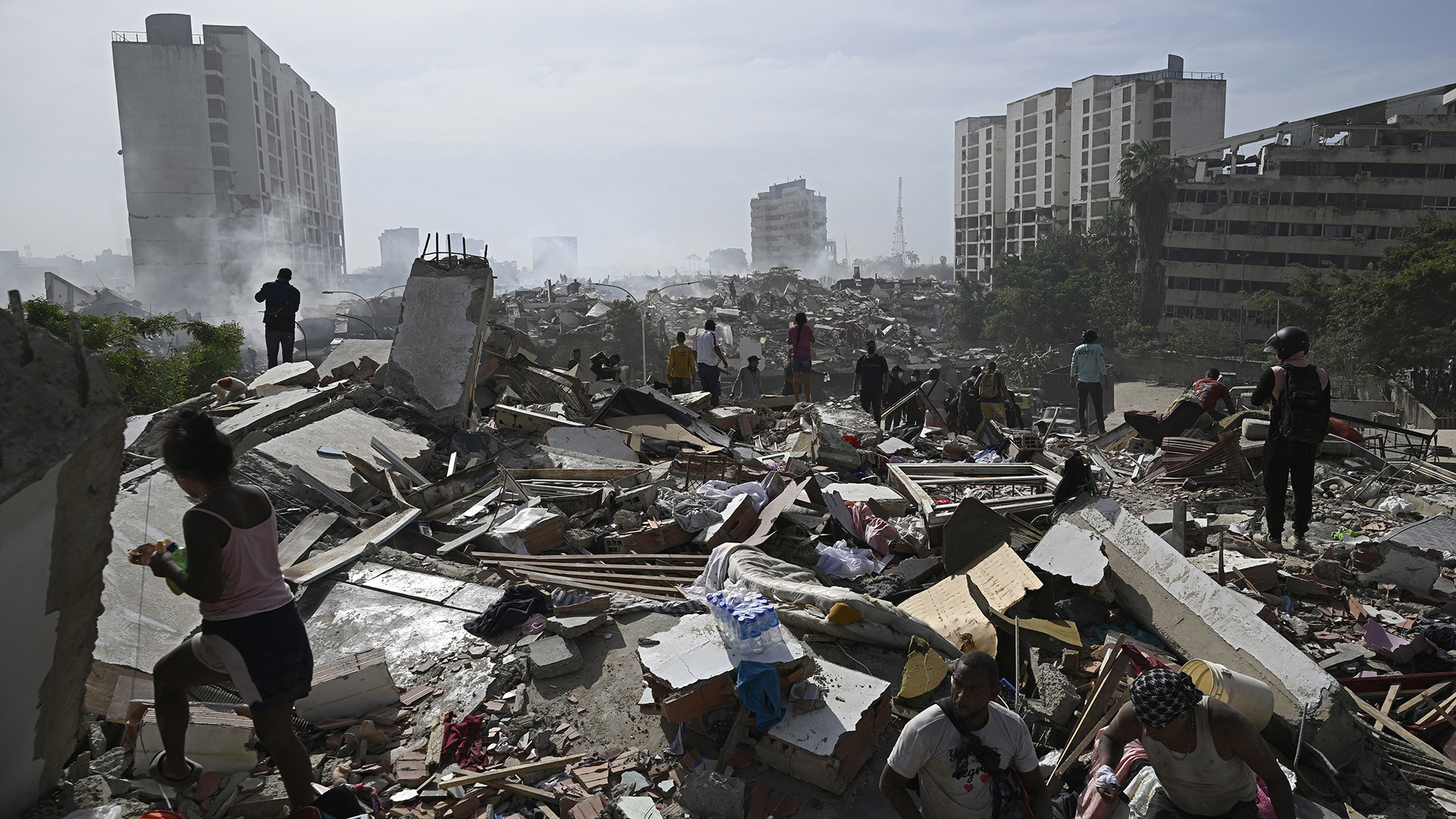 People search through the rubble following a twin earthquake in Caraballeda near Caracas, Venezuela