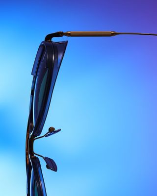 Close up image of the '‘Echo’' sunglasses arm and lenses, blue faded back ground