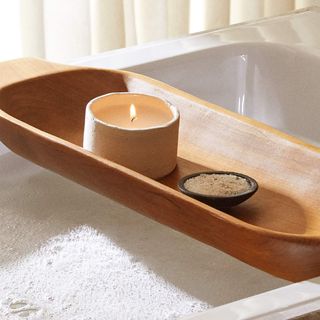 Wooden bath tray with candle and bath salts